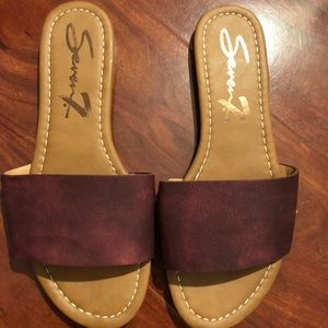 Seven maroon leather slides